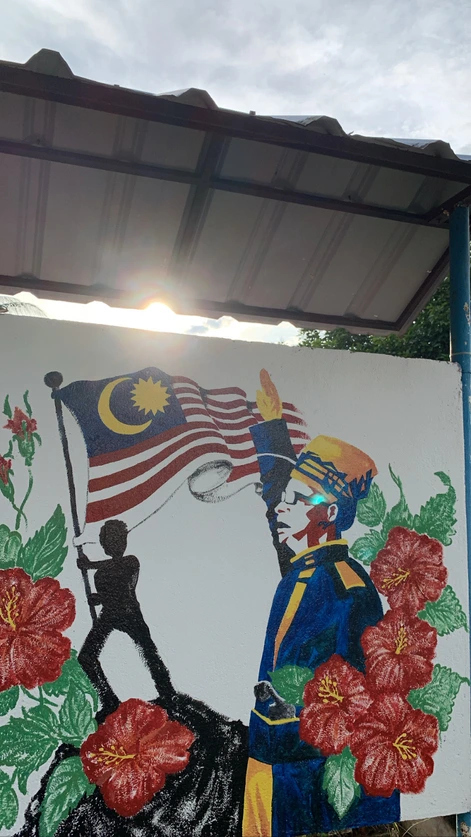 Village mural with the Malaysian flag and hibiscus flowers